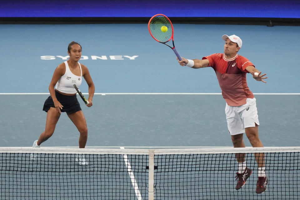 Canada's Leylah Fernandez, left, watches mixed doubles partner Steven Diez play a shot to Chile's Daniela Seguel and Tomas Barrios Vera during the United Cup tennis tournament in Sydney, Sunday, Dec. 31, 2023. (AP Photo/Rick Rycroft)