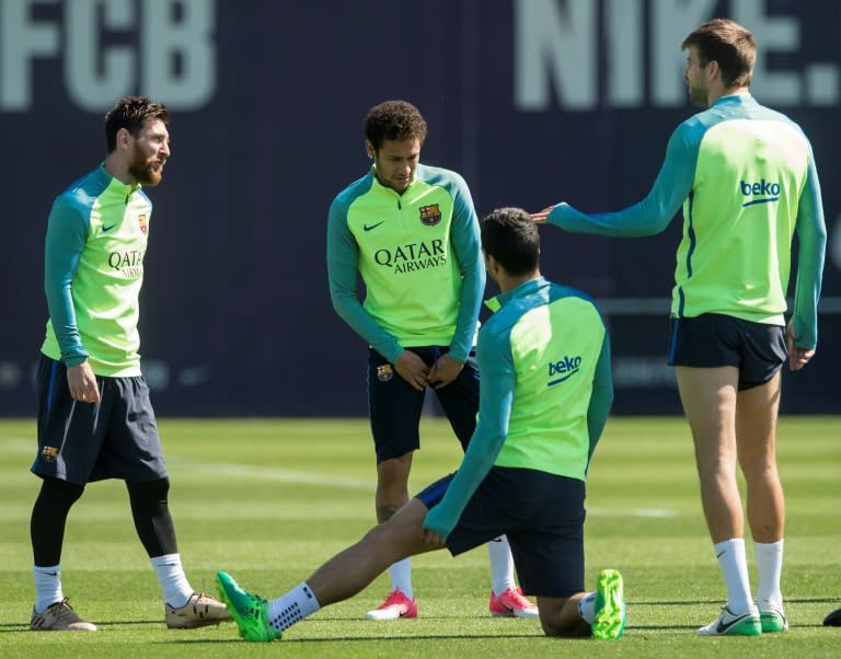 Barcelona's Lionel Messi (L) chats with teammate Neymar (2ndL) and Gerard Pique (R) during a training session at the Sports Center FC Barcelona Joan Gamper in Sant Joan Despi, near Barcelona, on April 22, 2017