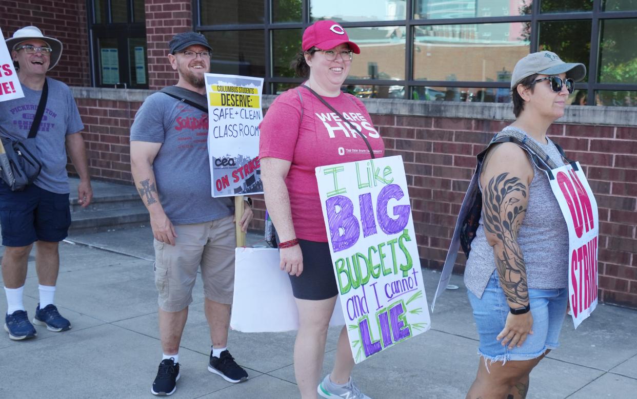 Seibert Elementary teacher Melissa Van-Hoose holds a sign saying "I like big budgets and cannot lie" when Columbus Education Association members were picketing last week. Union members approved an agreement with the district on Sunday.