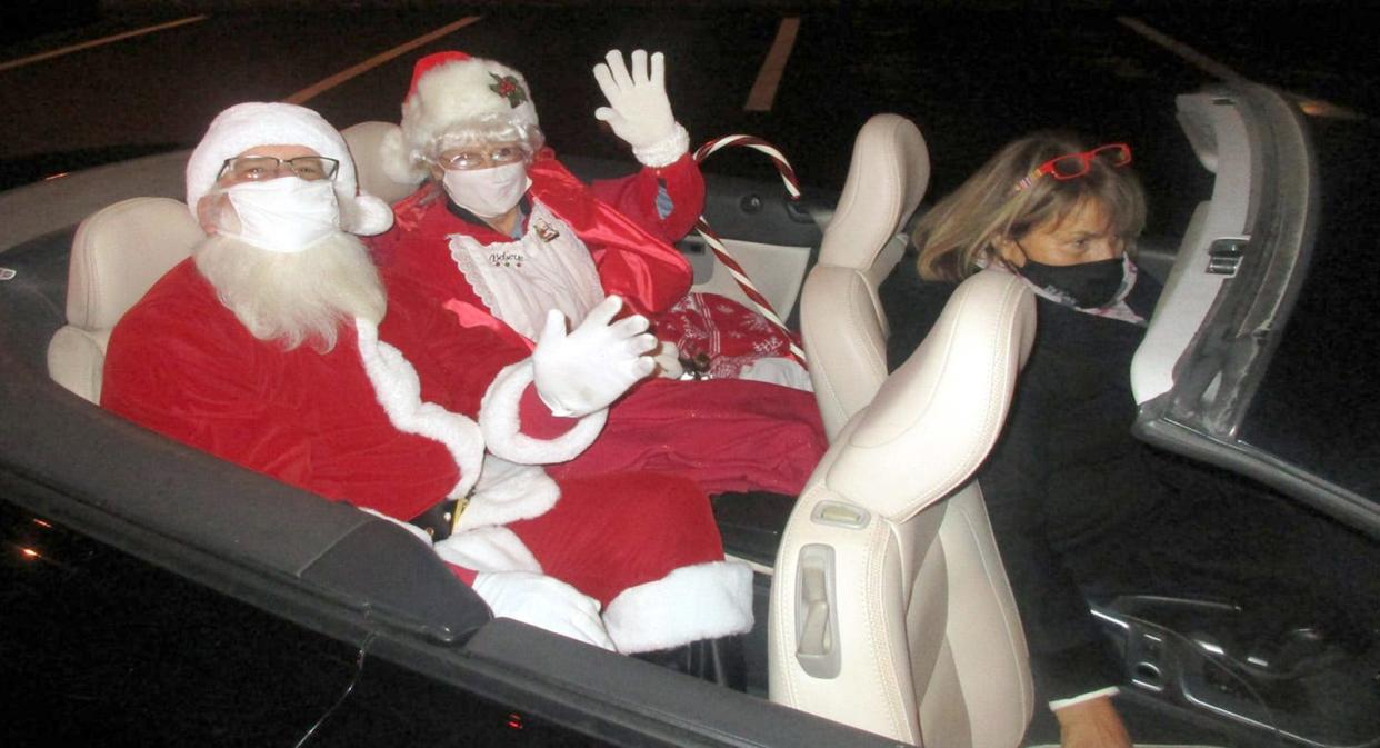 Hamilton Mayor RuthAnn Loveless escorts Santa and Mrs. Claus through the village last December in this file photo. The annual Night of Lights holiday celebration returns to the Village Green at 6 p.m. Dec. 3. 