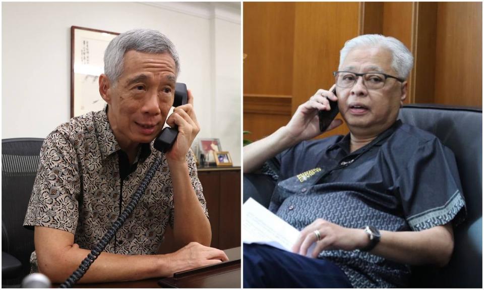 Singapore's Prime Minister Lee Hsien Loong (left) on his congratulatory phone call with Malaysia's newly appointed Prime Minister Ismail Sabri (right). (PHOTOS: MCI / PMO Malaysia)