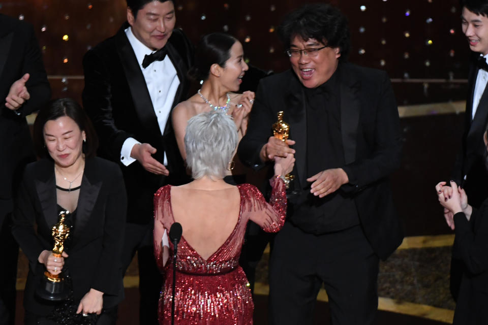 Kwak Sin-ae and Bong Joon Ho are greeted by Jane Fonda as they accept the award for Best Picture for "Parasite." (Photo: Mark Ralston via Getty Images)