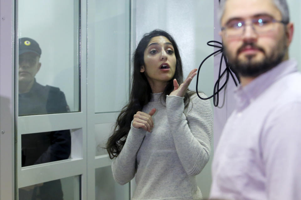 Israeli Naama Issachar gestures during an appeal hearings in a courtroom in Moscow, Russia, Thursday, Dec. 19, 2019. An Israeli backpacker serving prison time in Russia on a drug conviction is appealing her case and says she was wasn't provided a translator or lawyer after being detained at a Moscow airport. She was arrested in April in Moscow's Sheremetyevo Airport, where she was transferring flights en route from India to Israel. More than nine grams of hashish were found in her luggage. She was later sentenced to 7 1/2 years. (AP Photo/Alexander Zemlianichenko Jr.)