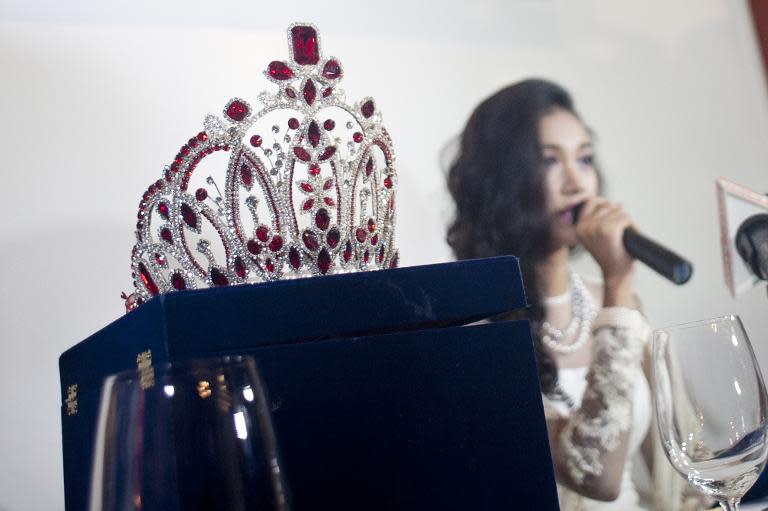 May Myat Noe, winner of Miss Asia Pacific World Super talent 2014, sits next to her crown at a press conference in Yangon on September 2, 2014