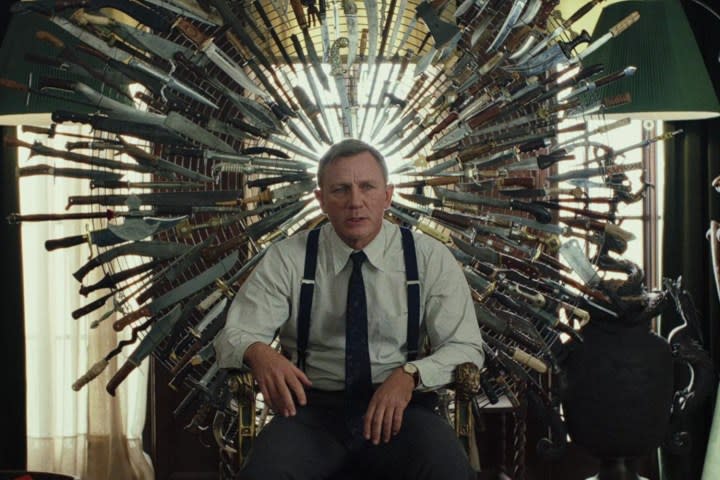 Daniel Craig sits on a throne of knives.