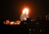 Smoke and flames rise above a building during Israeli air strikes, amid a flare-up of Israeli-Palestinian fighting, in Gaza City