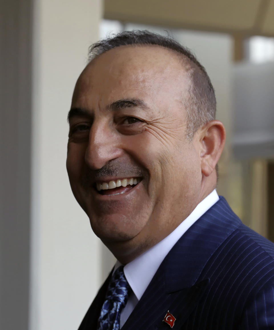 Turkey's Foreign Minister Mevlut Cavusoglu speaks to journalists in Ankara, Turkey, Monday, Oct. 28, 2019. Cavusoglu says the Turkish military will attack any Syrian Kurdish fighter that remains along the border area in northeast Syria after a deadline for them to leave expires.(AP Photo/Burhan Ozbilici)