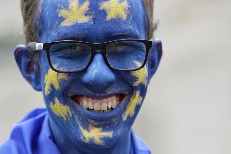 A demonstrator with his face painted in the EU colors waits for the start of a Peoples Vote anti-Brexit march in London, Saturday, March 23, 2019. The march, organized by the People's Vote campaign is calling for a final vote on any proposed Brexit deal. This week the EU has granted Britain's Prime Minister Theresa May a delay to the Brexit process. (AP Photo/Kirsty Wigglesworth)
