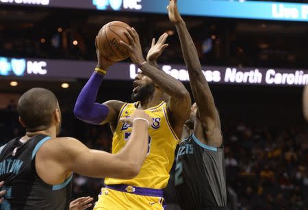 Dec 15, 2018; Charlotte, NC, USA; Los Angeles Lakers forward LeBron James (23) drives on Charlotte Hornets guard Tony Parker (9) and forward Marvin Williams (2) during the first half at the Spectrum Center. Mandatory Credit: Sam Sharpe-USA TODAY Sports