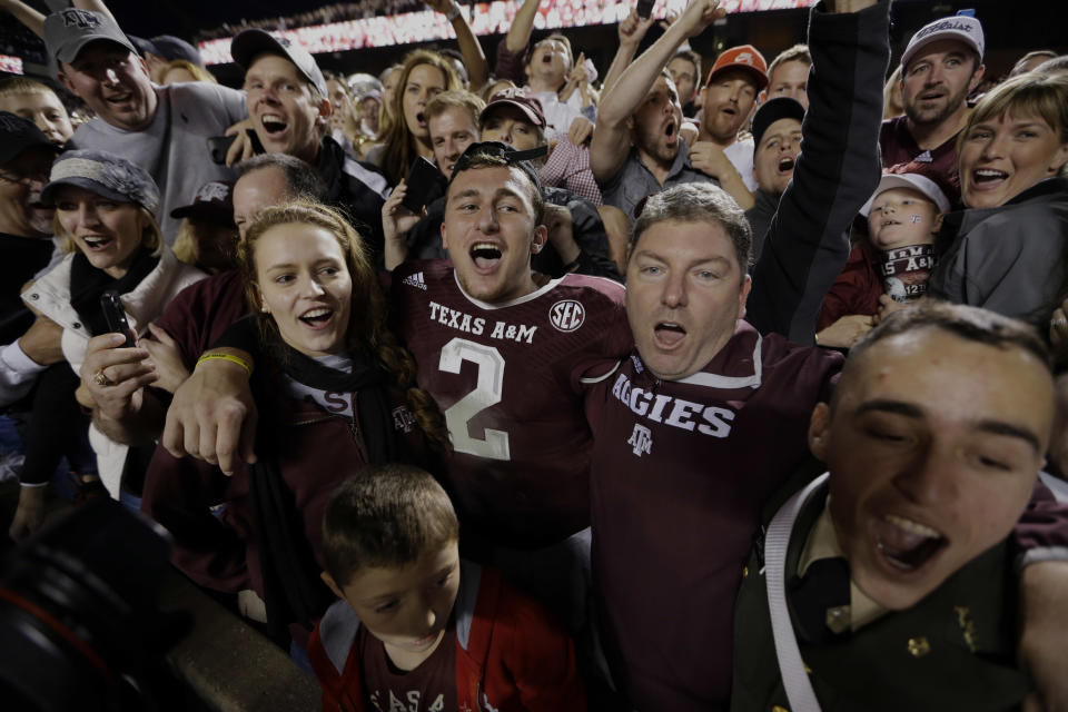 Texas A&M quarterback Johnny Manziel (2) celebrates with fans after an NCAA college football game against Mississippi State Saturday, Nov. 9, 2013, in College Station, Texas. Texas A&M won 51-41. (AP Photo/David J. Phillip)