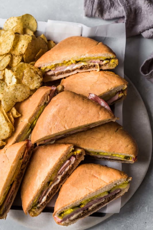 <p>Platings and Pairings</p><p>This sheet pan Cubano sandwich is the ultimate Cuban slider recipe. Thinly sliced ham, Cuban marinated pork and gruyere cheese are layered with pickles and mustard and then baked on a weighted sheet pan, resulting in a crispy, delicious sandwich.</p><p><strong>Get the recipe: <a href="https://www.platingsandpairings.com/sheet-pan-cubano-sandwich/" rel="nofollow noopener" target="_blank" data-ylk="slk:Sheet Pan Cubano Sandwich Sliders;elm:context_link;itc:0;sec:content-canvas" class="link ">Sheet Pan Cubano Sandwich Sliders</a></strong></p><p><strong>Related: <a href="https://parade.com/958103/pipandebby/best-party-slider-recipes/" rel="nofollow noopener" target="_blank" data-ylk="slk:45 Easy Party Slider Recipes;elm:context_link;itc:0;sec:content-canvas" class="link ">45 Easy Party Slider Recipes</a></strong></p>