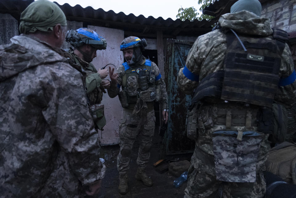 Ukrainian servicemen from the 3rd Assault Brigade gather as they deploy to frontline positions near Andriivka, Donetsk region, Ukraine, Friday, Sept. 15, 2023. Ukrainian brigade's two-month battle to fight its way through a charred forest shows the challenges of the country's counteroffensive in the east and south. (AP Photo/Mstyslav Chernov)