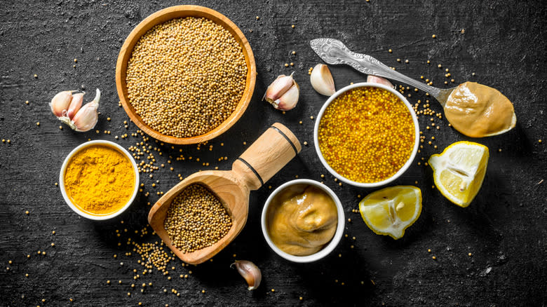 Different types of mustard on gray counter