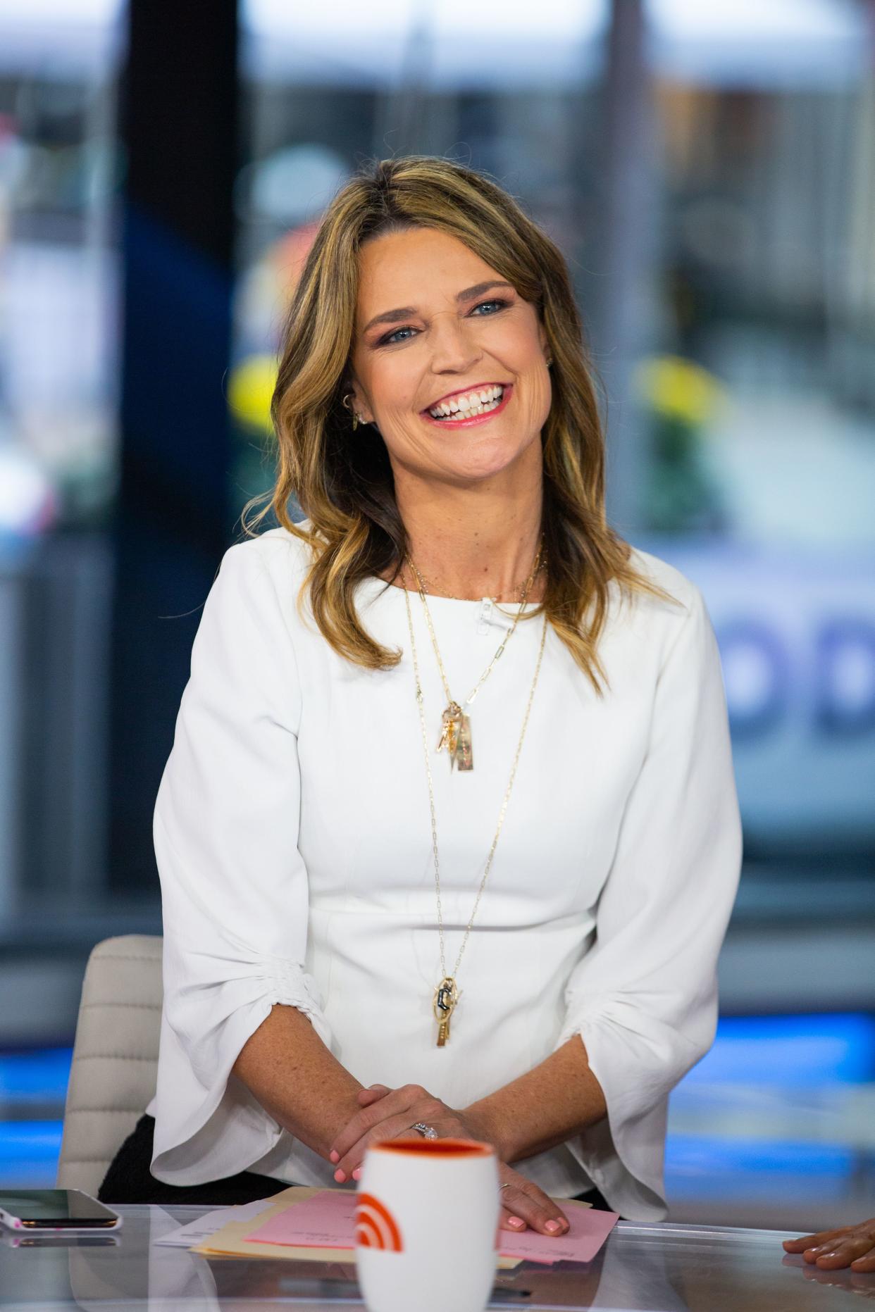 Savannah Guthrie smiles sitting at the Today Show news desk