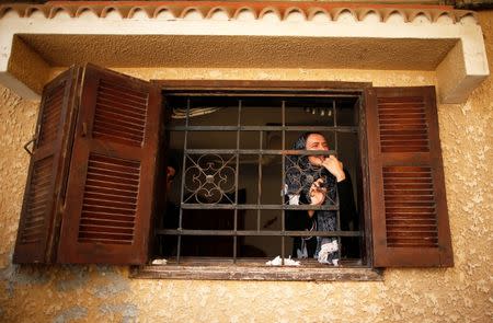 A relative of Palestinian militant Mohammed Abu Dakah, 31, who was killed in an Israeli strike, mourns during his funeral in Khan Younis in the southern Gaza Strip July 21, 2018. REUTERS/Suhaib Salem