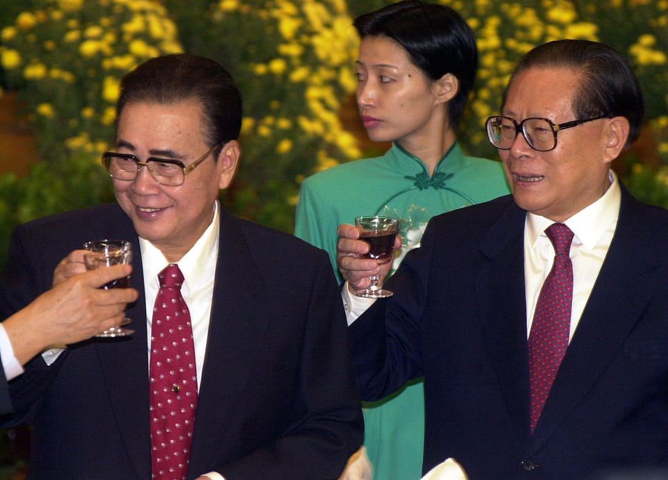 CORRECTS AGE TO 90, INSTEAD OF 91 - FILE - In this Set. 30, 1999, file photo, then Chinese President Jiang Zemin, right, and Li Peng, then chairman of National People's Congress raise a glass for toast at a banquet marking the 50th anniversary of the establishment of People's Republic in Beijing. Li Peng, a former hard-line Chinese premier best known for announcing martial law during the 1989 Tiananmen Square pro-democracy protests, has died. He was 90. The official Xinhua News Agency said that Li died Monday, July 22, 2019 of an unspecified illness. (AP Photo/Chung Chien-min, File)