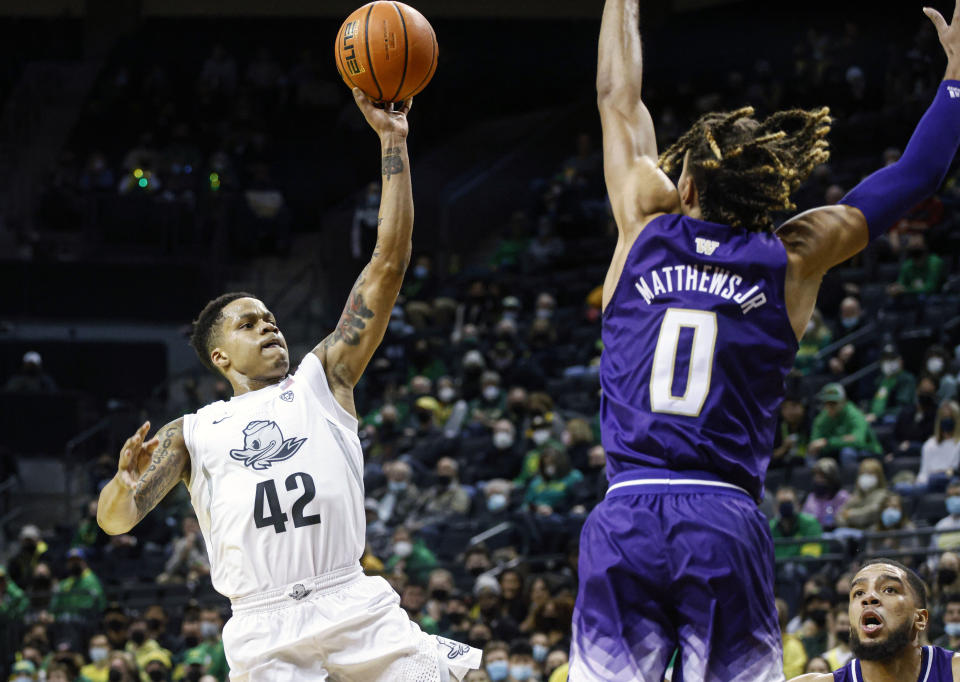 Oregon guard Jacob Young (42) shoots against Washington in the first half of an NCAA college basketball game in Eugene, Ore., Sunday, Jan. 23, 2022. (AP Photo/Thomas Boyd)