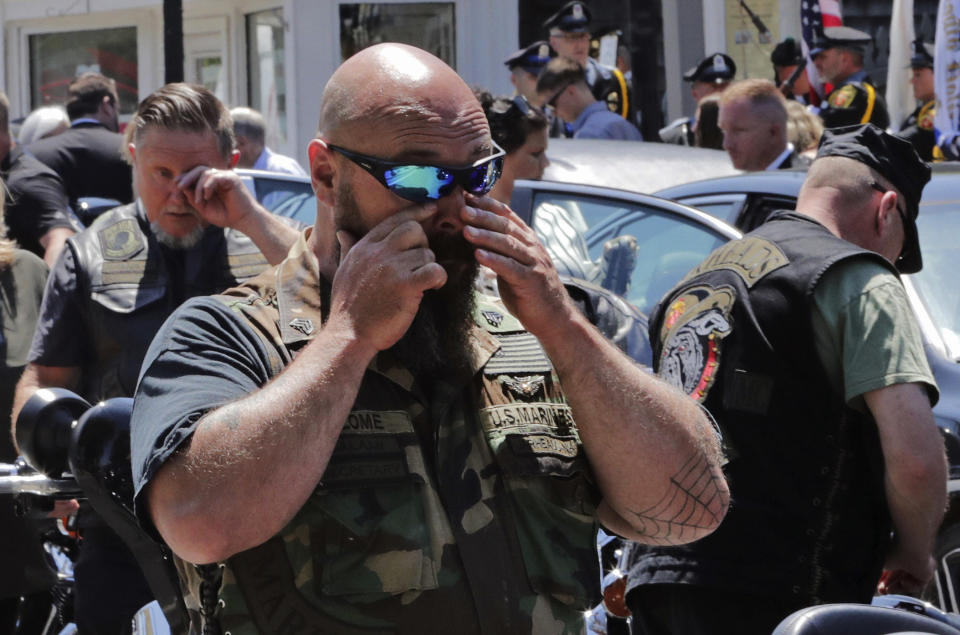 Members of the Jarheads Motorcycle Club react after the casket of Michael Ferazzi was loaded into a hearse following a funeral at St. Peter's Catholic Church in Plymouth, Mass., Friday, June 28, 2019. Ferazzi, a motorcyclist and retired police officer, was killed in a fiery crash that claimed the lives of seven people riding with the Jarheads Motorcycle Club in New Hampshire. (AP Photo/Charles Krupa)