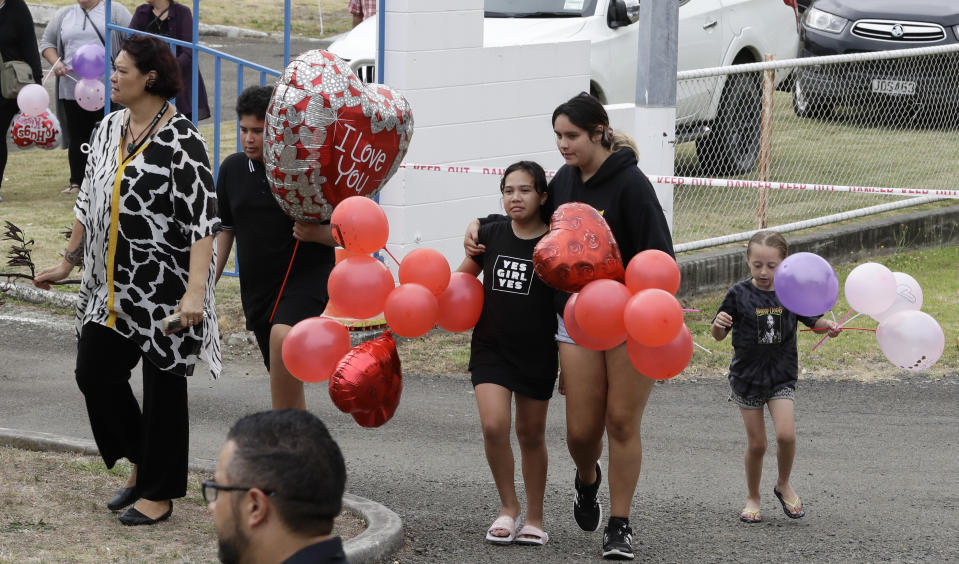 Families of victims of the White Island eruption arrive a the Whakatane wharf following a blessing at sea ahead of the recovery operation off the coast of Whakatane New Zealand, Friday, Dec. 13, 2019. A team of eight New Zealand military specialists landed on White Island early Friday to retrieve the bodies of victims after the Dec. 9 eruption. (AP Photo/Mark Baker)