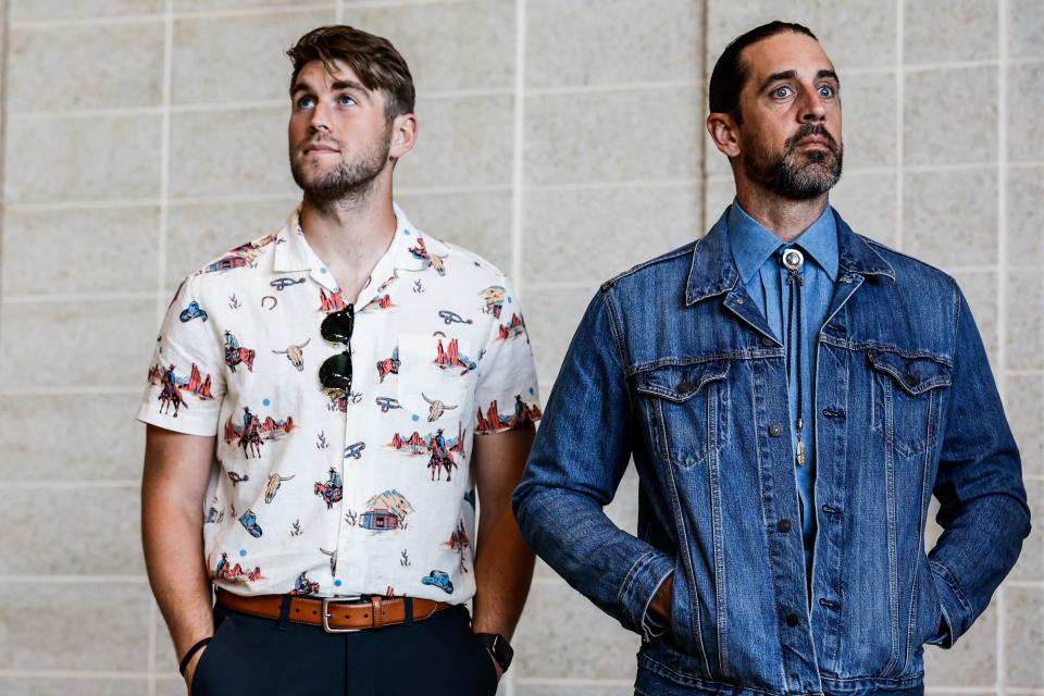 A denim-clad Aaron Rodgers appears with backup Green Bay Packers quarterback Danny Etling on Wednesday, Aug. 24, 2022 during the Welcome Back Packers Luncheon in the Lambeau Field Atrium.