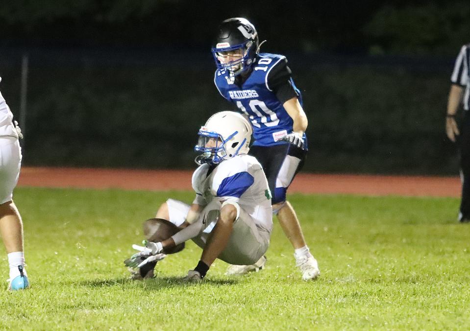 Colchester defensive back Mason Sheltra makes an interception during the Lakers 18-0 win over U-32 on Thursday night at CHS.