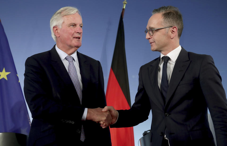 German Foreign Minister Heiko Maas, right, and EU brexit Chief Negotiator Michel Barnier, left, shake hands after a joint press conference as part of a meeting at the foreign ministry in Berlin, Germany, Monday, Sept. 23, 2019. (AP Photo/Michael Sohn)