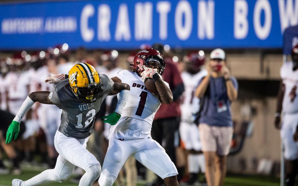 Jeff Davis' Quantavious Rogers (12) shoves Dothan's Octavious Thomas (1) out of bounds at Cramton Bowl in Montgomery, Ala., on Thursday, Oct. 27, 2022. Dothan leads Jeff Davis 31-6 at halftime.