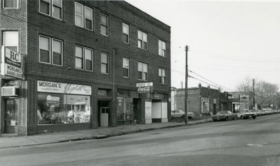 A 1969 photograph shows businesses on Wooster Avenue in Akron . Morgan's Barber Shop and Elizabeth's Beauty Shop are pictured.
