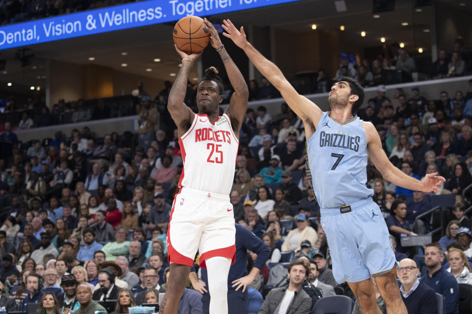 Houston Rockets guard Reggie Bullock Jr. (25) shoots while defended by Memphis Grizzlies forward Santi Aldama (7) during the first half of an NBA basketball game Friday, Dec. 15, 2023, in Memphis, Tenn. (AP Photo/Nikki Boertman)