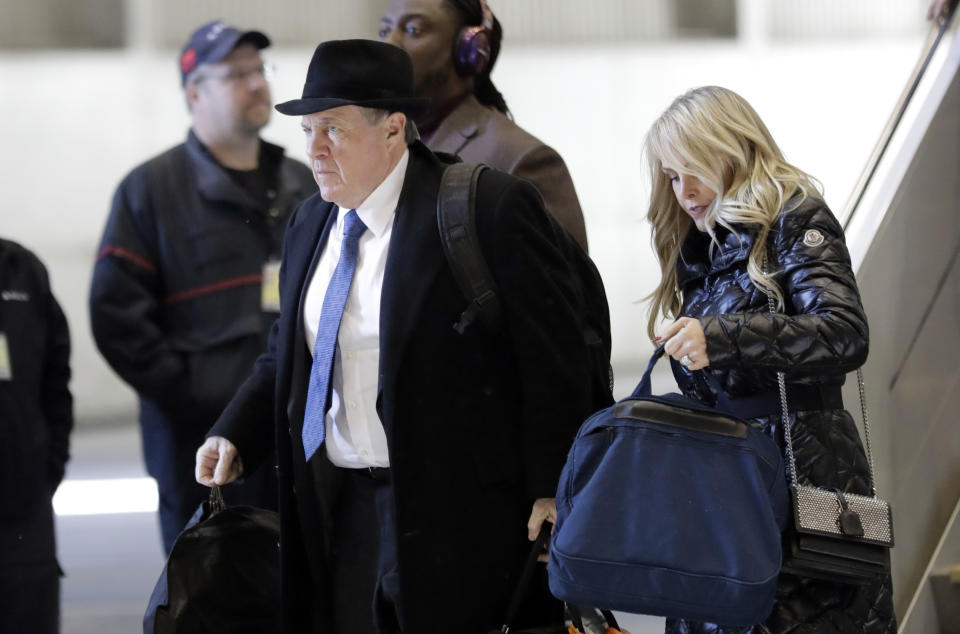 New England Patriots head coach Bill Belichick, left, arrives with his wife Debby, right, and team for the NFL Super Bowl 52 football game Monday, Jan. 29, 2018, in Minneapolis. New England is scheduled to face the Philadelphia Eagles Sunday. (AP Photo/Eric Gay)