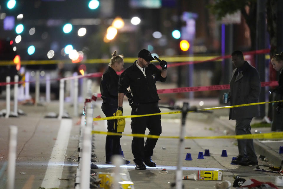 Denver Police Department investigators work the scene of a mass shooting along Market Street between 20th and 21st avenues during a celebration after the Denver Nuggets won the team's first NBA Championship early Tuesday, June 13, 2023, in Denver. (AP Photo/David Zalubowski)