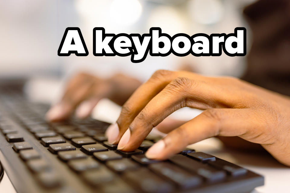 Close-up of hands typing on a keyboard in a well-lit environment