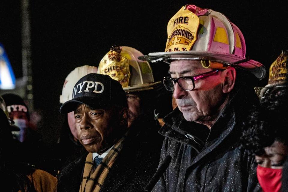 adams in nypd cap, nigro in firefighting gear