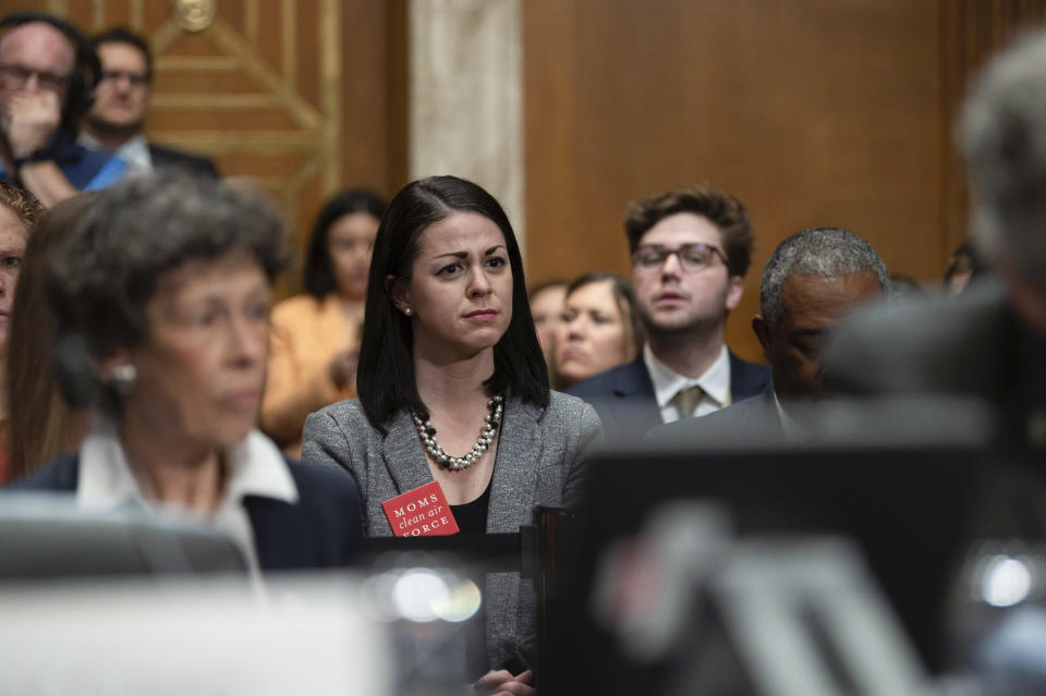 East Palestine, Ohio, resident Misti Allison, center, reacts to testimony during a Senate Environment and Public Works Committee hearing to examine protecting public health and the environment in the wake of the Norfolk Southern train derailment in East Palestine, Thursday, March 9, 2023, in Washington. (AP Photo/Kevin Wolf)