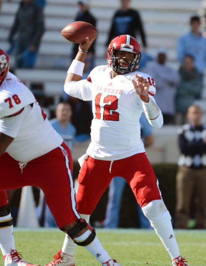 Nov 29, 2014; Chapel Hill, NC, USA; North Carolina State Wolfpack quarterback Jacoby Brissett (12) throws a pass during the first half against the North Carolina Tar Heels at Kenan Memorial Stadium Mandatory Credit: Rob Kinnan-USA Today