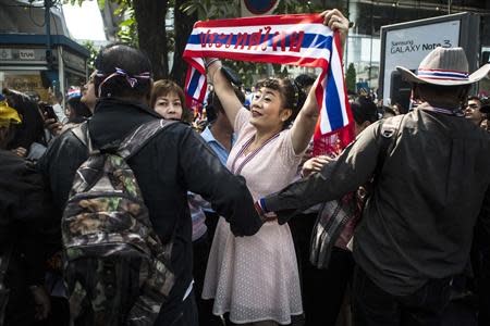 An anti-government supporter reacts as protest leader Suthep Thaugsuban (not seen) leads a rally in Bangkok's financial district January 23, 2014. REUTERS/Nir Elias