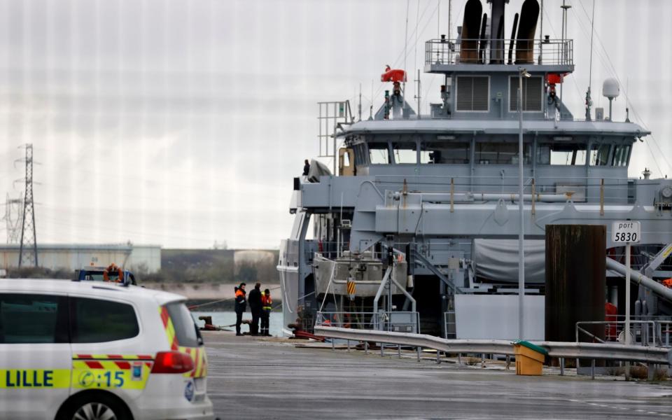 French rescue workers stand next to a rescue vessel during a search operation after a boat capsized off the coast of Loon-Plage near Dunkirk - REUTERS/Pascal Rossignol