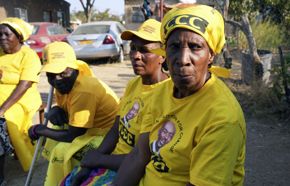 Four women look on in Zimbabwe's rural Domboshava area, Wednesday, Aug. 16 2023. People in Zimbabwe's rural areas claim they are facing intimidation and a biased state-run media which limits their ability to support opposition parties ahead of national elections next week. To combat that, one group of grandmothers is using the WhatsApp messaging app to spread information from the opposition party they support in an attempt to cut through the propaganda. (AP Photo/Tsvangirayi Mukwazhi)