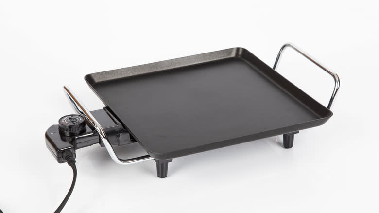 Electric griddle on white background