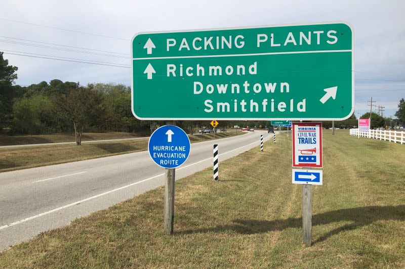 FILE PHOTO: A road sign directs traffic to Smithfield Foods' pork processing facilities in Smithfield