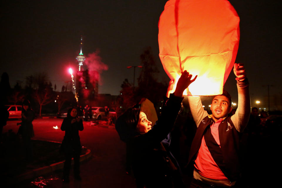 In this picture taken on Tuesday, March 18, 2014, Iranian release a lit lantern during a celebration, known as “Chaharshanbe Souri,” or Wednesday Feast, marking the eve of the last Wednesday of the solar Persian year, in Pardisan park, Tehran, Iran. March 21, the first day of spring, marks Nowruz, the beginning of the year 1393 on the Persian calendar. (AP Photo/Ebrahim Noroozi)
