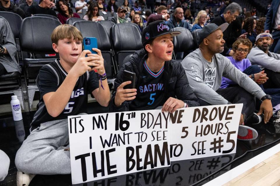 Cole Beamer, left, sits with friend Miles Coburn of San Luis Obispo, who would have his 16th birthday wish to see the beam granted, before an NBA game between the Sacramento Kings and the Phoenix Suns on Friday, Dec. 22, 2023, at Golden 1 Center.