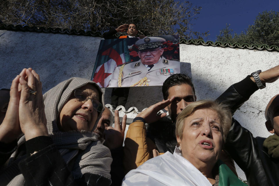 People gather during the funeral Gen. Ahmed Gaid Salah, in Algiers, Algeria, Wednesday, Dec. 25, 2019. Algeria is holding an elaborate military funeral for the general who was the de facto ruler of the gas-rich country amid political turmoil throughout this year. (AP Photo/Toufik Doudou)