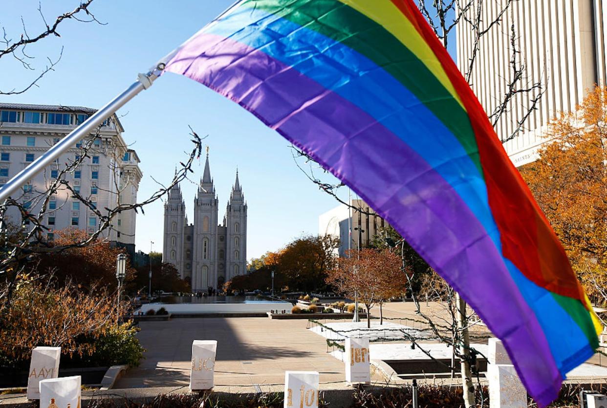 A pride flag flies in front of the historic temple of the Church of Jesus Christ of Latter-day Saints in Salt Lake City, Utah. <a href="https://www.gettyimages.com/detail/news-photo/pride-flag-flies-in-front-of-the-historic-mormon-temple-as-news-photo/497172074?phrase=gay%20latter-day%20saint&adppopup=true" rel="nofollow noopener" target="_blank" data-ylk="slk:George Frey/Getty Images;elm:context_link;itc:0;sec:content-canvas" class="link ">George Frey/Getty Images</a>