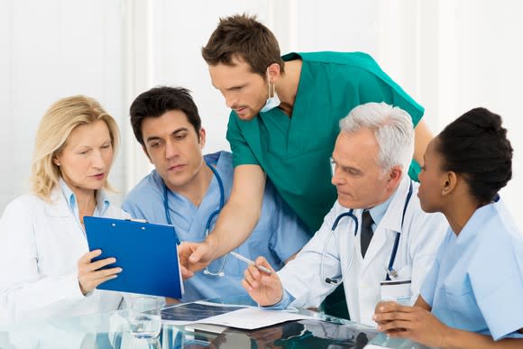 Team of doctors looking over data