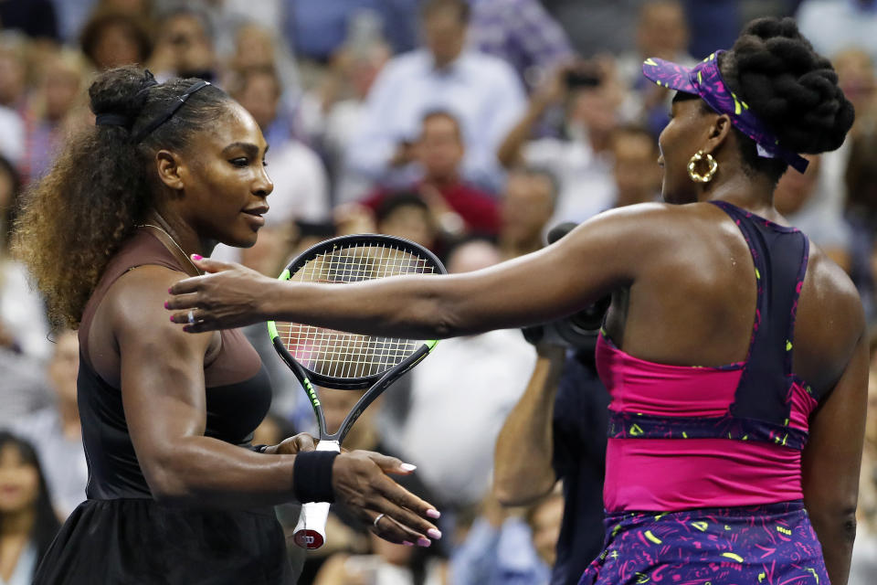 Serena Williams, left, meets her sister Venus Williams after their match during the third round of the U.S. Open tennis tournament, Friday, Aug. 31, 2018, in New York. Serena Williams won 6-1, 6-2. (AP Photo/Adam Hunger)