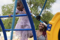 Tamika Davis, right, spends time with her daughter, Shanara, 3, at MLK Park in San Antonio, Thursday, May 30, 2024. Davis said friends and family watched her kids for most of her doctor visits during treatment last year for colon cancer. But she couldn't afford additional childcare, and she didn't know where to look for assistance. (AP Photo/Eric Gay)