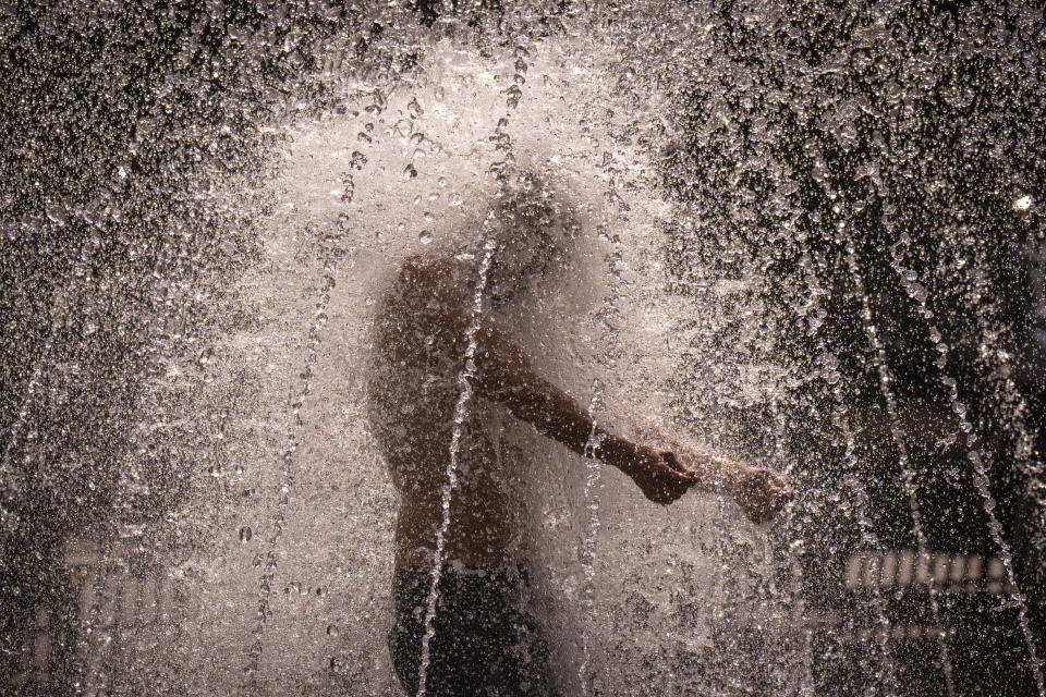 FILE - A man stands in a fountain in Bucharest, Romania, on a hot afternoon, July 25, 2023. European climate monitoring organization made it official: July 2023 was Earth's hottest month on record by a wide margin. (AP Photo/Andreea Alexandru, File)