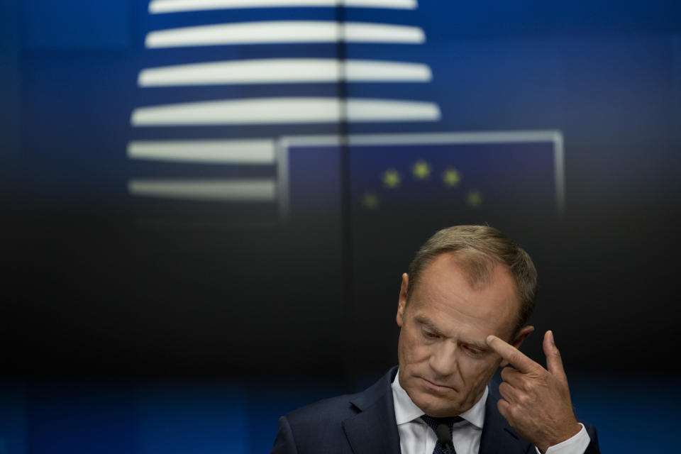 European Council President Donald Tusk touches his eyebrow after delivering a statement during a joint news conference following a Tripartite Social Summit roundtable at the European Council headquarters in Brussels, Tuesday, Oct. 16, 2018. (AP Photo/Francisco Seco)