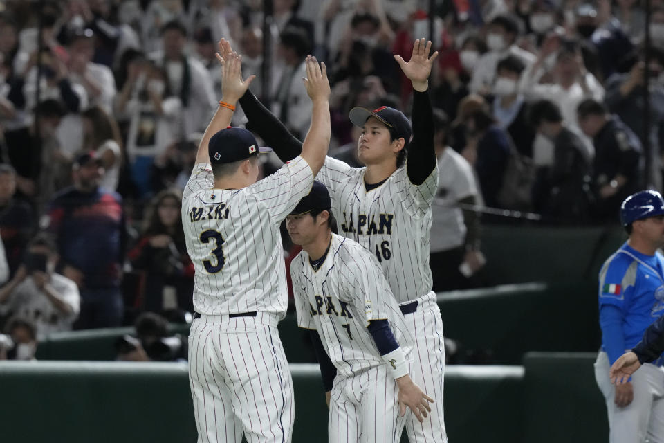 Shohei Ohtani of Japan celebrates with Shugo Maki of Japan and Takumu Nakano of Japan after defeating Italy in the quarterfinal game between Italy and Japan at the World Baseball Classic (WBC) at Tokyo Dome in Tokyo, Japan, Thursday, March 16, 2023. (AP Photo/Eugene Hoshiko)